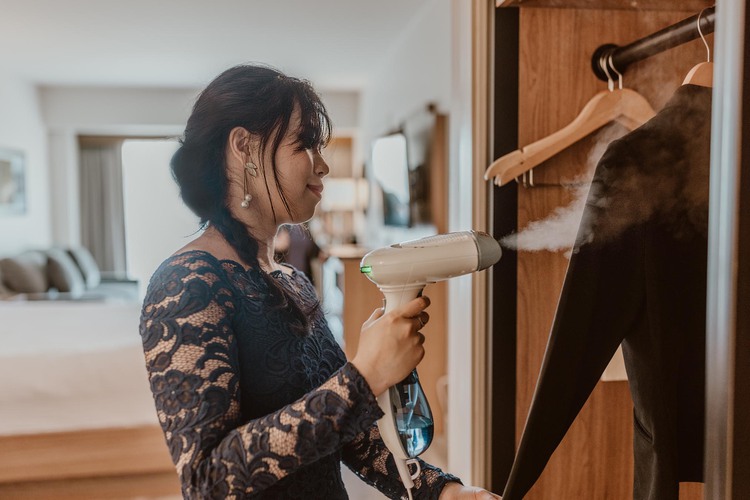 Woman steaming clothing