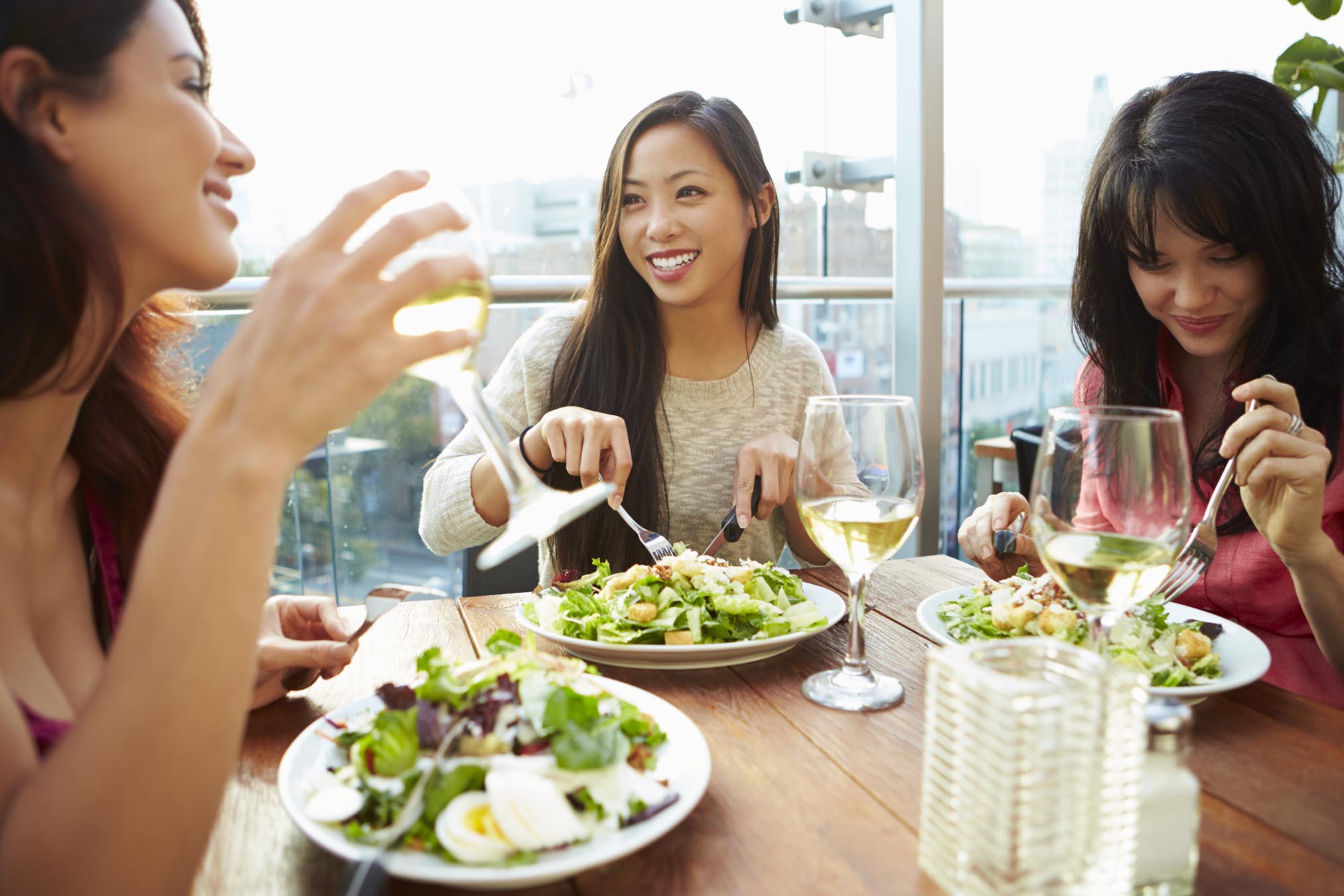 Group of friends eating salads